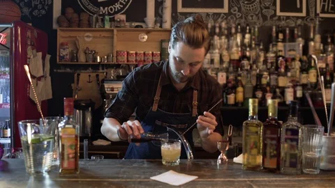 Trendy bearded man working as a bartender in a nightclub bar Stock Footage 96145672