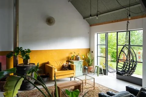 Trendy Boho eclectic interior with vintage furniture. Stock Photos