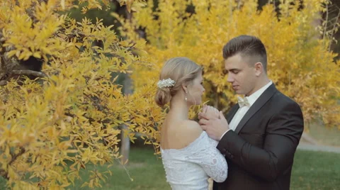 Trendy bride warm  hands of his graceful bride Stock Footage 44576352