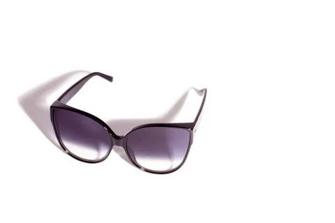 Trendy cat eye dark gradient sunglasses in fine black plastic frame. Stock Photos