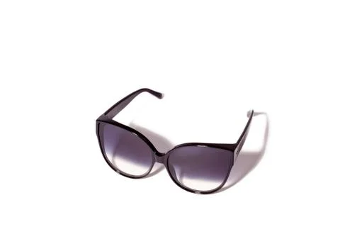 Trendy cat eye dark gradient sunglasses in fine black plastic frame. Stock Photos
