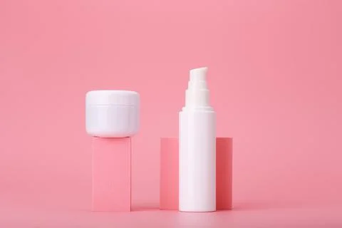 Trendy composition with set of cosmetic jars on geometric shapes against pink Stock Illustration