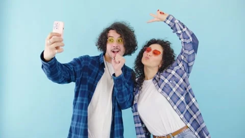 A Trendy Couple Is Seen Taking a Fun Selfie while Wearing Vibrant Sunglasses Stock Footage 281036171