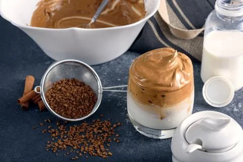 Trendy dalgona coffee, process of making on gray kitchen table Stock Photos