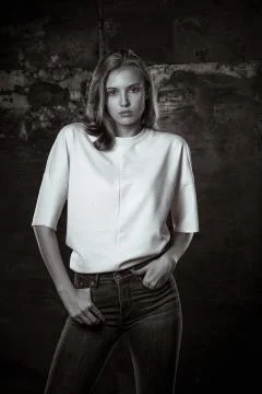 Trendy dressed adorable model posing at the wall Stock Photos