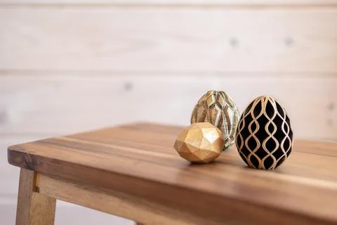 Trendy Easter low poly decor. Golden and black eggs of geometric style. Happy Stock Illustration