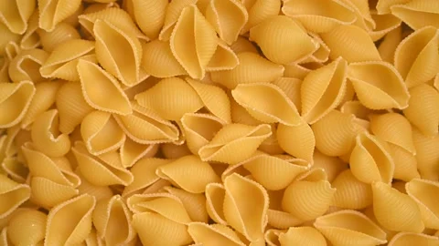Trendy flat view closeup rolling yellow macaroni. Top view, flat lay. Stock Footage 161622015