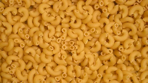 Trendy flat view closeup rolling yellow macaroni. Top view, flat lay. Stock Footage 161622022