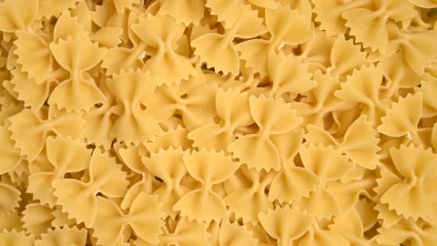 Trendy flat view closeup rolling yellow macaroni. Top view, flat lay Stock Footage 161622026