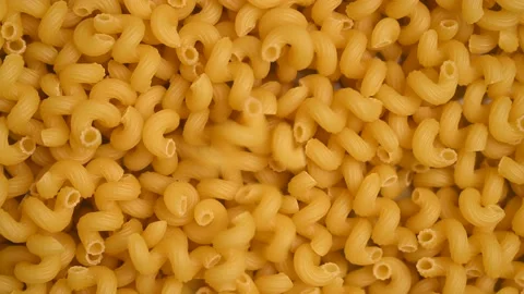 Trendy flat view closeup rolling yellow macaroni. Top view, flat lay. Stock Footage 161622027