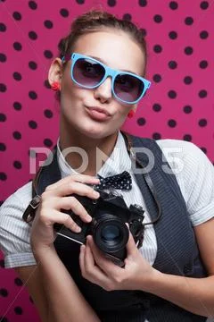 Trendy girl in glasses playing the ape with camera. duckface. pouting lips Stock Photos