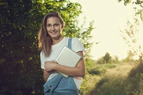 Trendy girl using a tablet pc outdoors Foto stock
