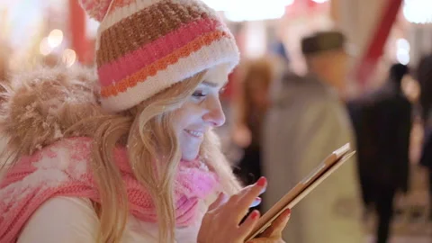 A trendy girl in winter city using digital tablet to find a good market Stock Footage 100674573