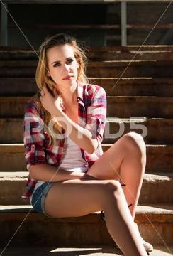 Trendy hipster girl in plaid shirt with sunglasses Stock Photos