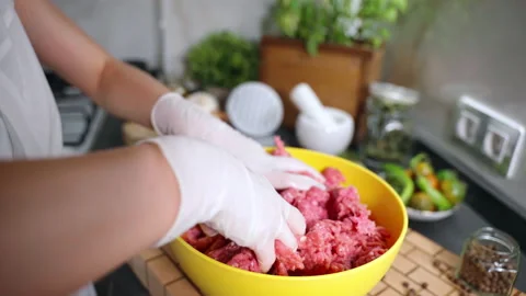 Trendy kitchen frame of mixing mince in yellow bowl, minced meat for burgers Stock Footage 223486010
