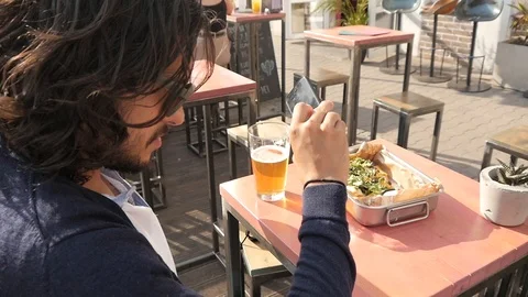 Trendy Latin Man With Mobile Iphone Make Photo Of Mexican Food Nachos and Beer Stock Footage 90494904