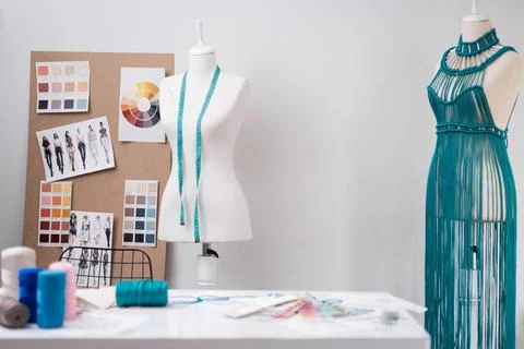 Trendy macrame dress of green threads in dummy in dressmaking shop sewing women Stock Photos