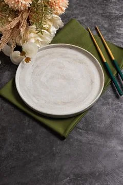 Trendy minimal tableware setting with the gray plate and golden chopsticks Stock Photos