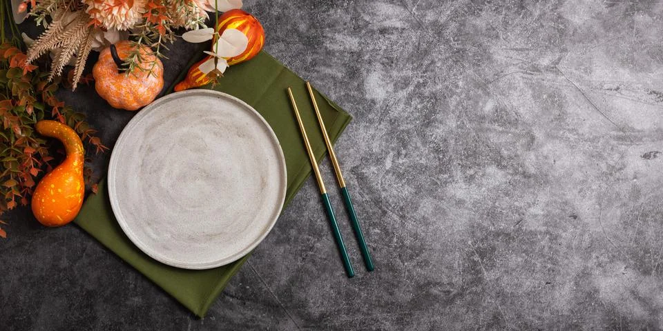 Trendy minimal tableware setting with the gray plate and golden chopsticks Stock Photos