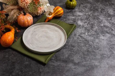 Trendy minimal tableware setting with the gray plate and golden cutlery Stock Photos