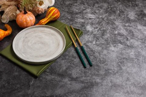 Trendy minimal tableware setting with the gray plate and golden chopsticks Stock Photos