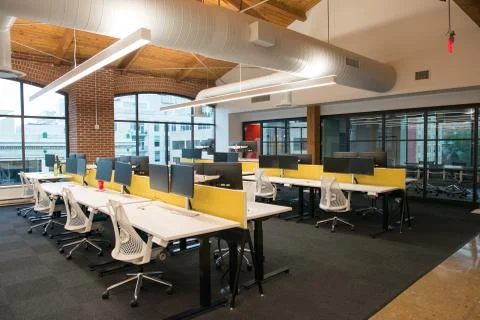Trendy modern open concept loft office space with big windows, natural light and Stock Photos