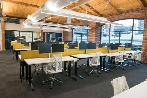 Trendy modern open concept loft office space with big windows, natural light and Stock Photos