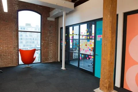 Trendy modern open concept loft office space with big windows, natural light and Stock Photos