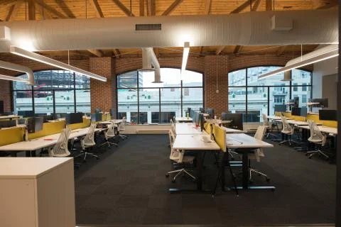 Trendy modern open concept loft office space with big windows, natural light and Stock Photos