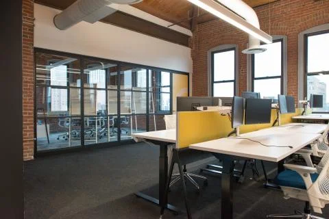 Trendy modern open concept loft office space with big windows, natural light and Stock Photos
