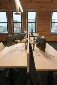 Trendy modern open concept loft office space with big windows, natural light and Stock Photos