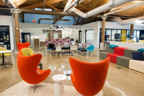 Trendy modern open concept loft office space with big windows, natural light and Stock Photos