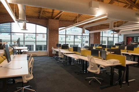 Trendy modern open concept loft office space with big windows, natural light and Stock Photos