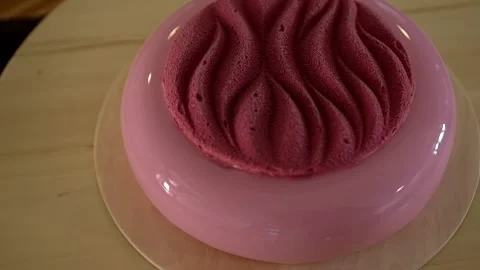 Trendy mousse cake with pink mirror glaze on wooden base. Modern dessert. Stock-Footage 159675048