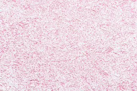 Trendy pattern of white sprinkles over pink background, decoration for donut  Stock Photos