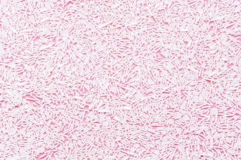 Trendy pattern of white sprinkles over pink background, decoration for donut  Stock Photos
