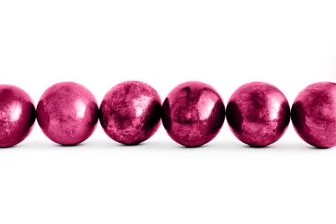 Trendy pink Easter eggs lined on isolated white background. Close-up. Stock Photos