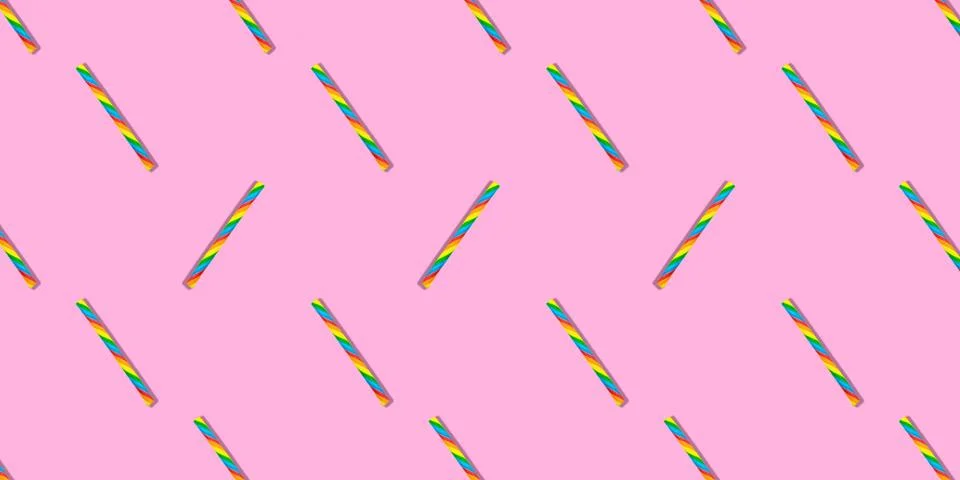 Trendy seamless candy stick pattern with shadows on pastel background, flat lay Stock Photos