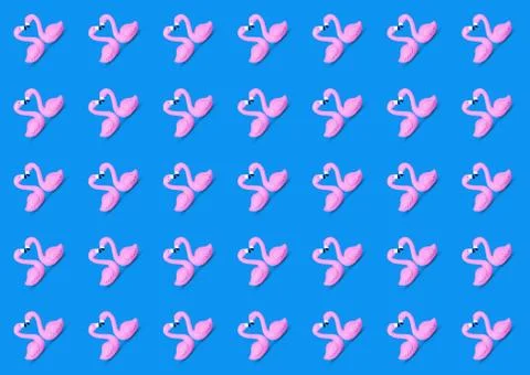 Trendy seamless summer pattern made of a pink toy flamingos Stock Photos