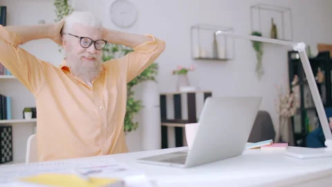 Trendy senior man resting from work, watching videos on laptop, procrastinating Video stock 210808226