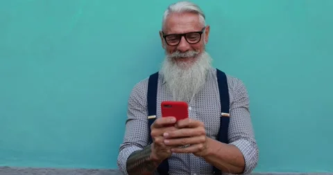 Trendy senior man using smartphone app Stock Footage 149117239