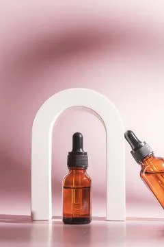 Trendy shoot of cosmetics packaging. Essential oil with natural ingredients. Stock Photos