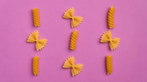 Trendy stop motion closeup moving yellow macaroni. Farfalle. Top view, flat lay. Stock Footage 162125382