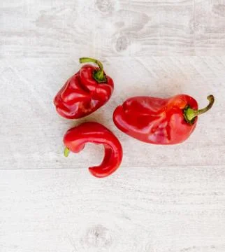 Trendy ugly organic peppers on the table. Stock Photos
