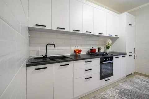 Trendy white modern kitchen interior with minimalistic furniture Foto stock