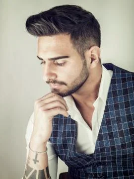 Trendy young man in studio shot wearing elegant vest Stock Photos