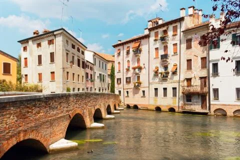 Treviso, Italy August 7, 2018: the river flows among the old buildings of the Stock Photos