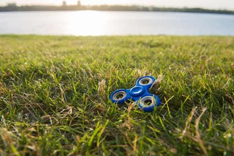 Tri Fidget Hand Spinner on the grass Stock Photos