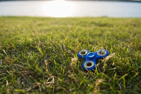 Tri Fidget Hand Spinner on the grass Stock Photos