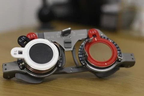 A trial frame with inserted trial lenses used for eye examinations in optomet Stock Photos